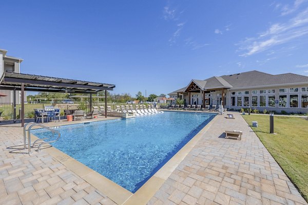 Modern pool with lounge chairs at Prose Prominence Apartments, a luxury community offering premium amenities for residents