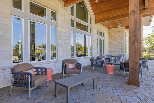 Stylish outdoor patio with comfortable seating at Prose Prominence Apartments