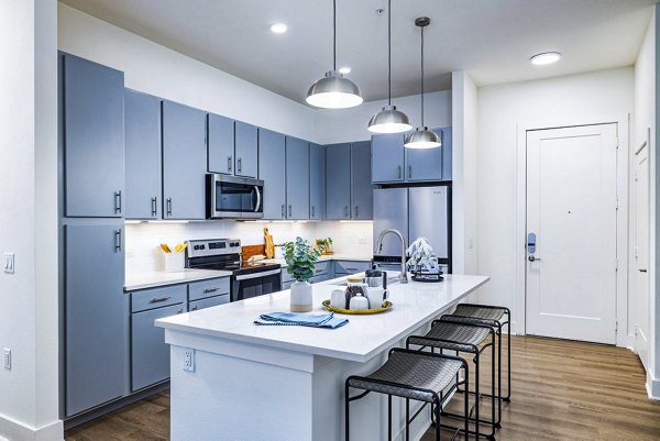Kitchen with modern appliances and sleek countertops at Legacy Encore Apartments