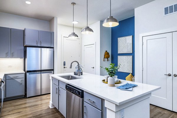 Modern kitchen with stainless steel appliances at Legacy Encore Apartments