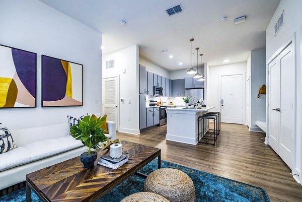 Living room with modern decor and open layout in Legacy Encore Apartments, a luxury property by Greystar in a vibrant community