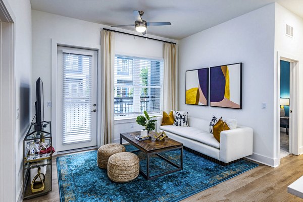 Spacious living room with elegant decor and large windows in Legacy Encore Apartments