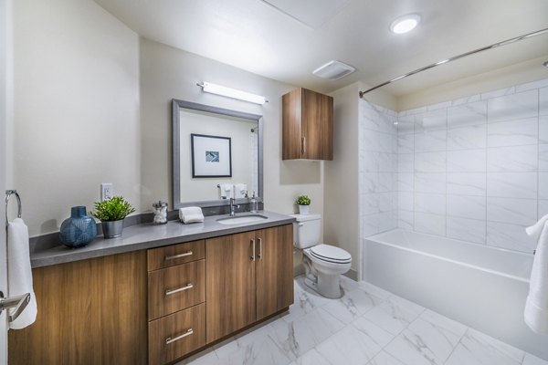 Bathroom with modern fixtures at Aliso Apartments featuring elegant design for luxury living