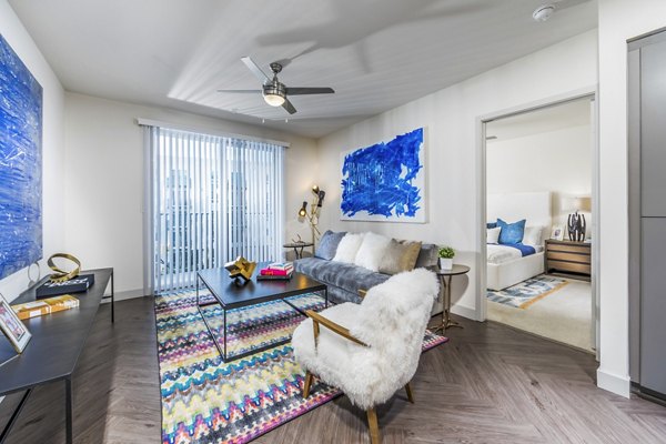 Spacious living room with contemporary furnishings at Aliso Apartments