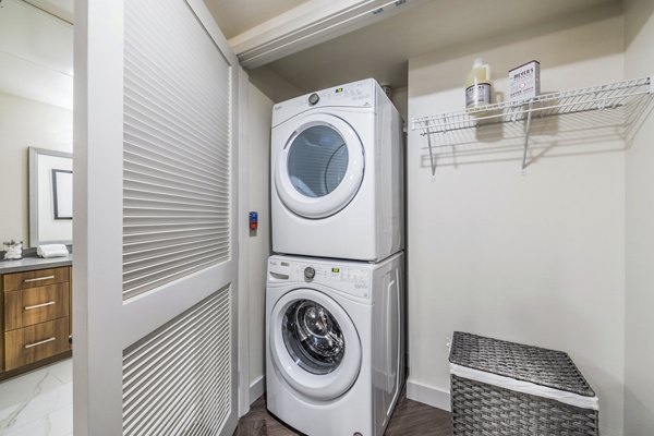 Laundry room equipped with modern appliances at Aliso Apartments