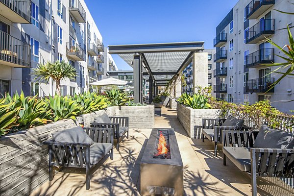 Cozy outdoor patio with a fire pit at Aliso Apartments for luxury outdoor gatherings