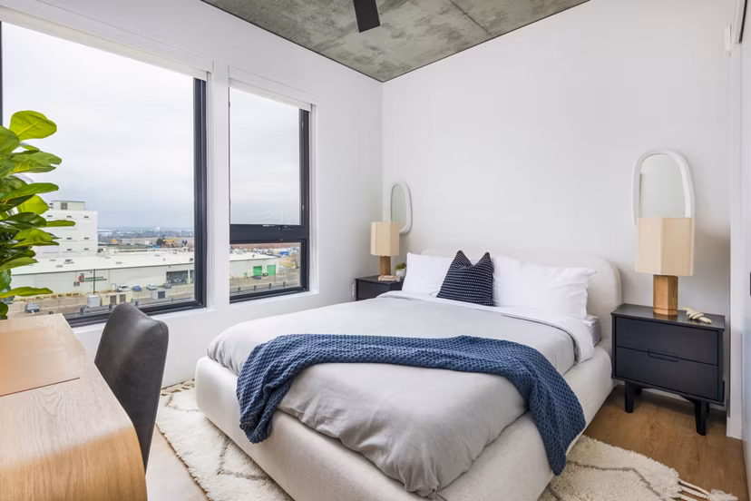 Modern bedroom with stylish furnishings at FoundryLine Apartments, offering luxury living in the heart of the community