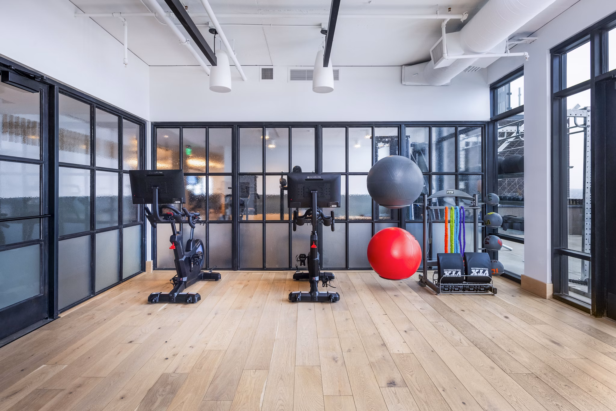 Modern yoga/spin studio with bright interiors at FoundryLine Apartments