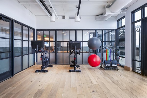 Modern yoga/spin studio with bright interiors at FoundryLine Apartments