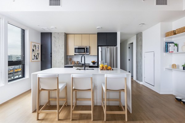 Modern kitchen with stainless steel appliances at FoundryLine Apartments: luxury living spaces in a vibrant community
