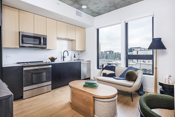 Modern kitchen with stainless steel appliances in FoundryLine Apartments