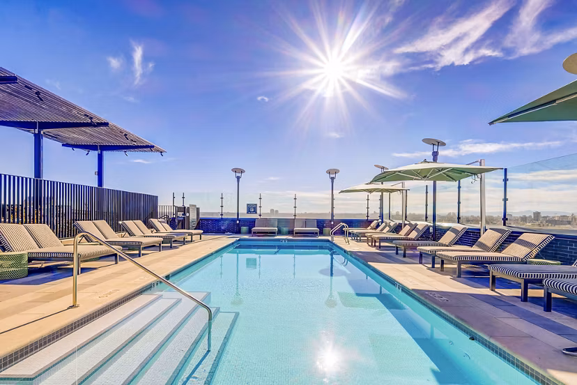 Resort-style pool with lush landscaping at FoundryLine Apartments, luxury living in a vibrant Greystar community