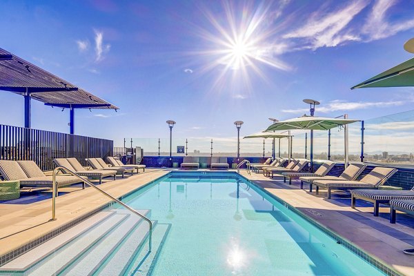 Resort-style pool with lush landscaping at FoundryLine Apartments, luxury living in a vibrant Greystar community