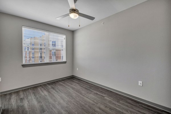 Cozy bedroom with plush carpeting and modern decor at Haven at Mansfield Apartments