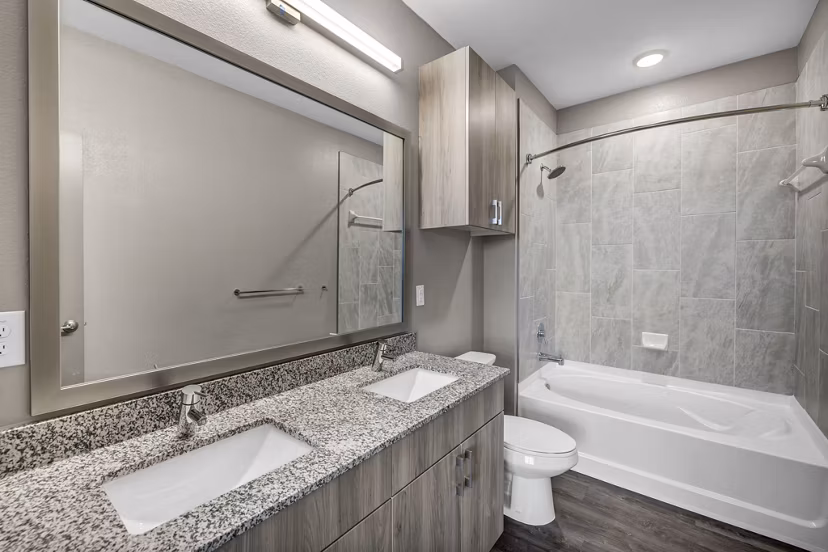 Modern bathroom with sleek fixtures and granite countertops at Haven at Mansfield Apartments