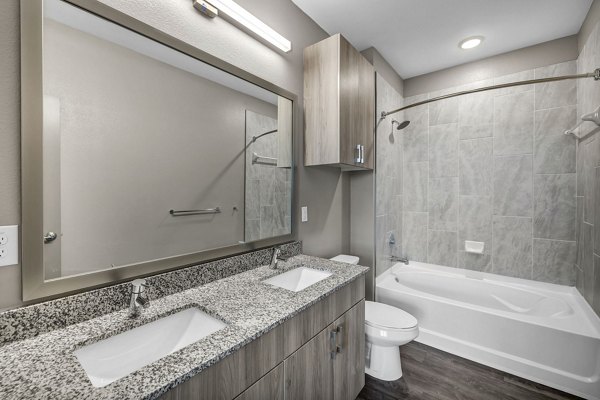 Modern bathroom with sleek fixtures and granite countertops at Haven at Mansfield Apartments