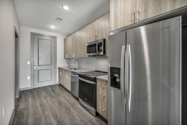 Modern kitchen with stainless steel appliances at Haven at Mansfield Apartments