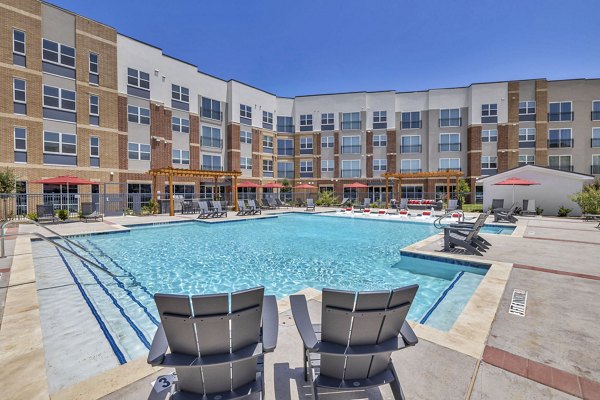 Haven at Mansfield: Expansive resort-style pool with sun loungers at luxury apartments