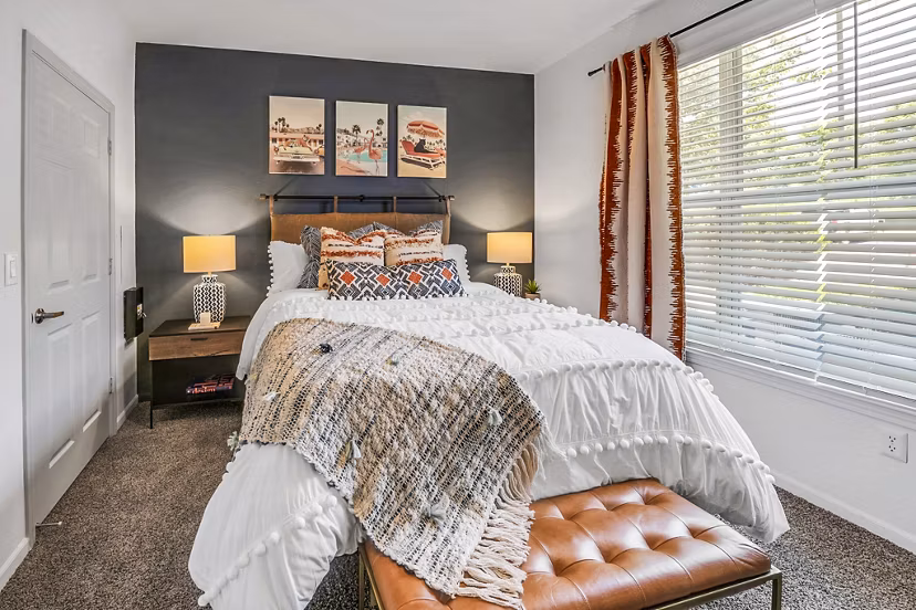 Elegant bedroom with contemporary decor and large windows at Aventura Clear Creek Apartments