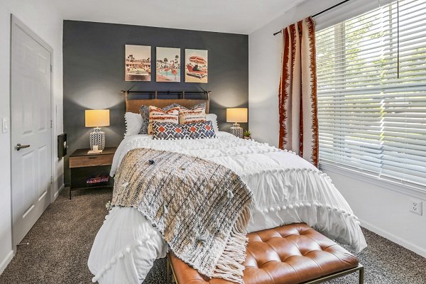 Elegant bedroom with contemporary decor and large windows at Aventura Clear Creek Apartments