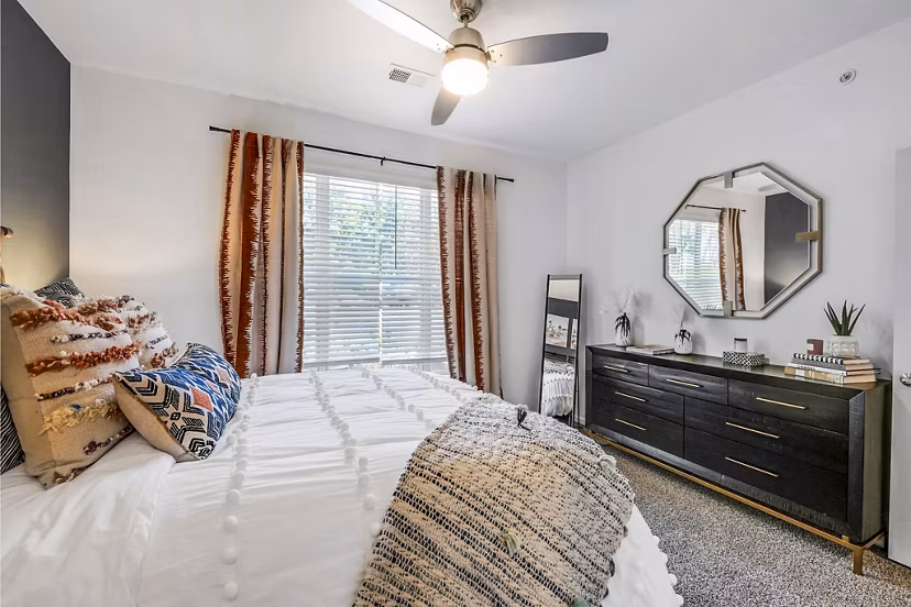 Bedroom with elegant decor at Aventura Clear Creek Apartments featuring neutral tones and natural light