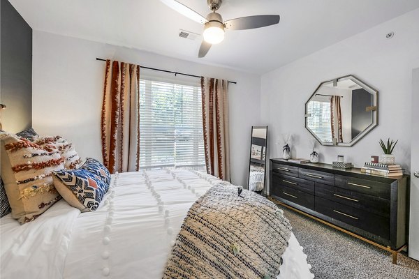 Bedroom with elegant decor at Aventura Clear Creek Apartments featuring neutral tones and natural light