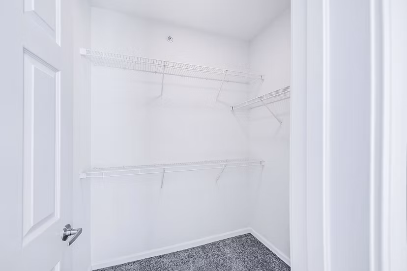 Spacious bedroom closet with built-in shelving in Aventura Clear Creek Apartments