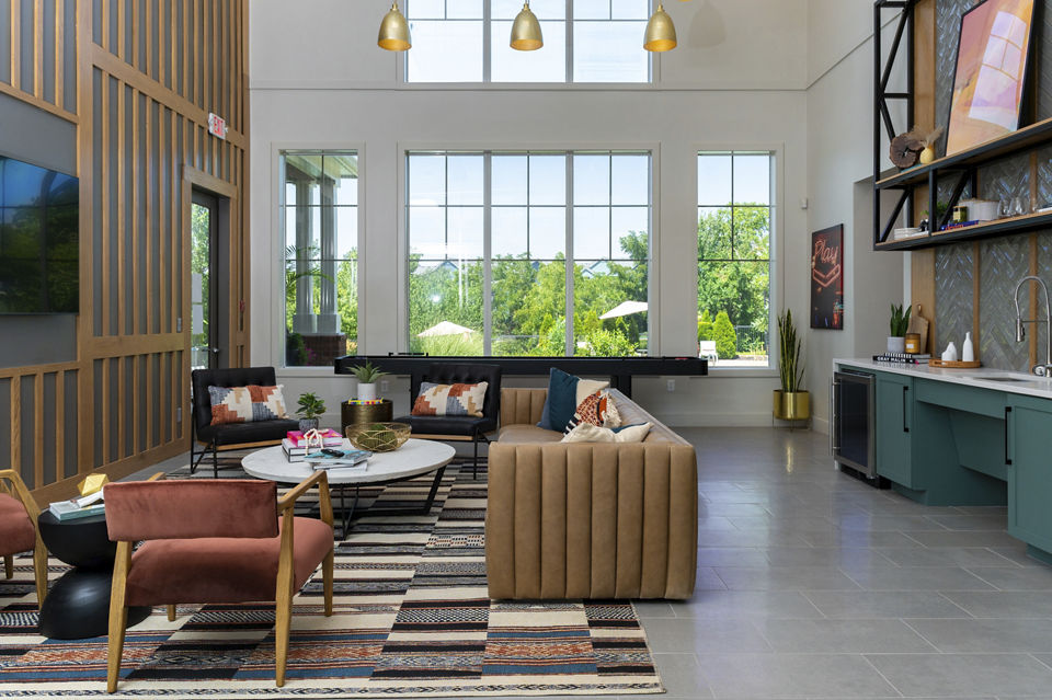 Clubhouse featuring modern design and inviting lounge spaces at Aventura Clear Creek Apartments