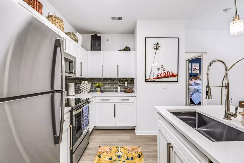 Modern kitchen with stainless steel appliances and granite countertops at Aventura Clear Creek Apartments