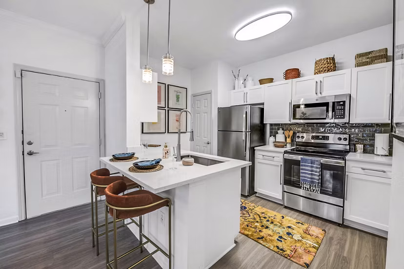 Modern kitchen with granite countertops and stainless steel appliances at Aventura Clear Creek Apartments