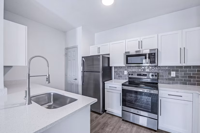 Modern kitchen with stainless steel appliances at Aventura Clear Creek Apartments