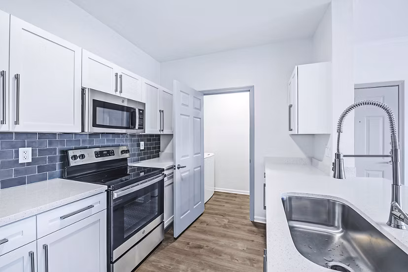Modern kitchen with stainless steel appliances in Aventura Clear Creek Apartments