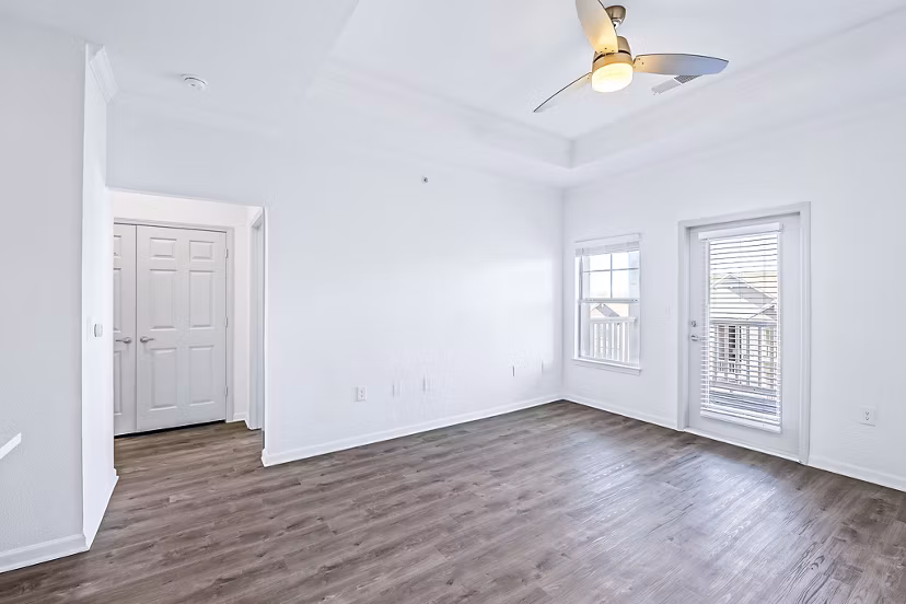 Living room with modern decor and large windows in Aventura Clear Creek Apartments