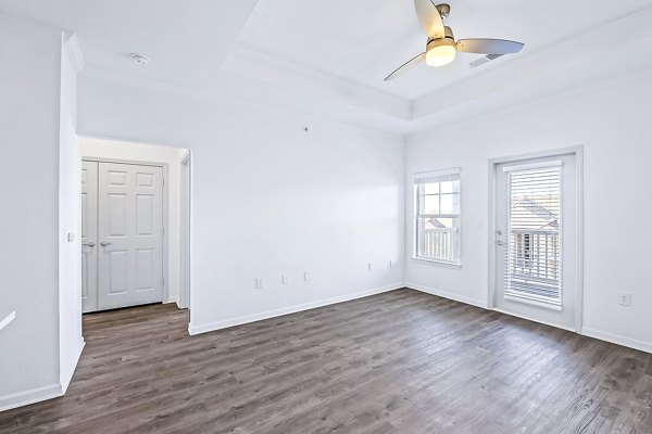 Living room with modern decor and large windows in Aventura Clear Creek Apartments