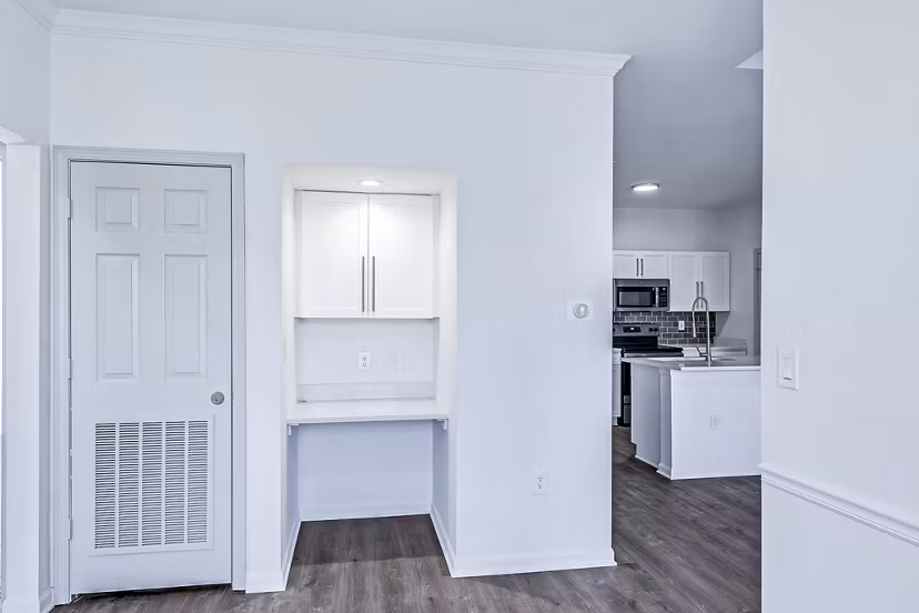 Home office with built-in desk and cozy living area in Aventura Clear Creek Apartments