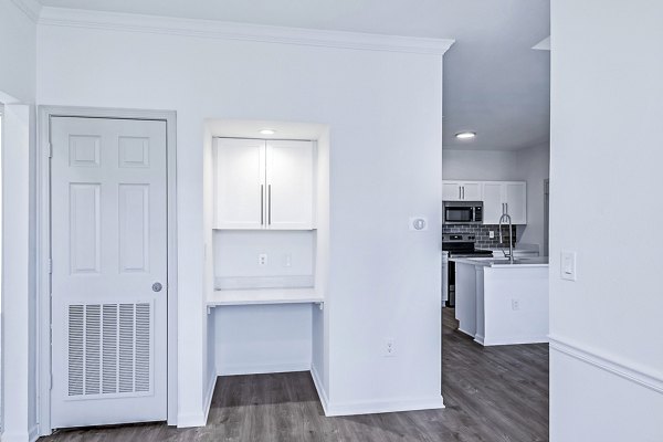 Home office with built-in desk and cozy living area in Aventura Clear Creek Apartments