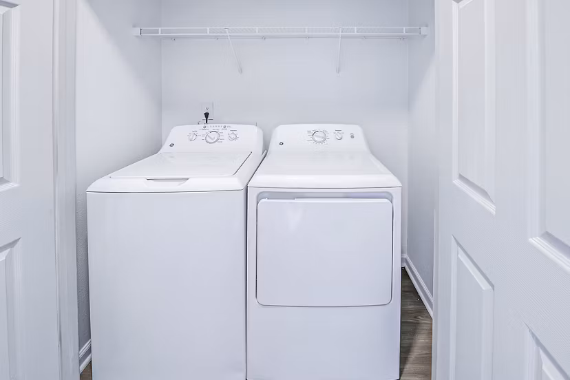 Laundry room with modern appliances at Aventura Clear Creek Apartments