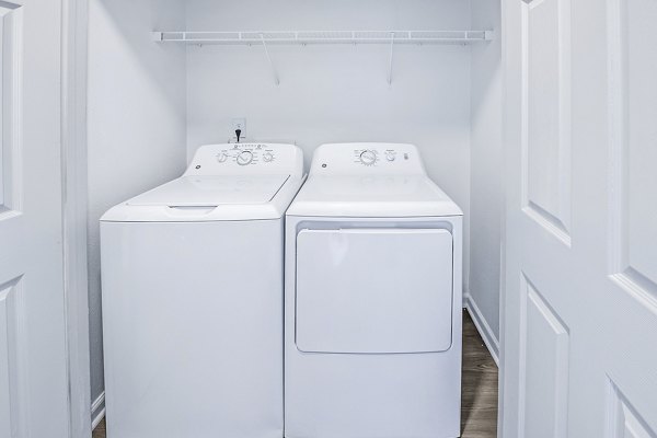 Laundry room with modern appliances at Aventura Clear Creek Apartments