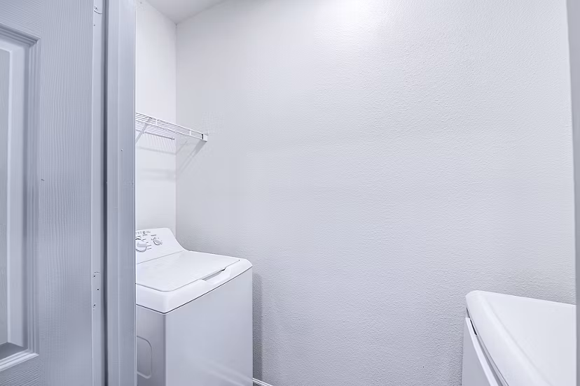 Modern laundry room with state-of-the-art machines at Aventura Clear Creek Apartments