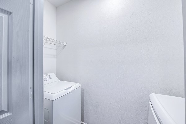 Modern laundry room with state-of-the-art machines at Aventura Clear Creek Apartments