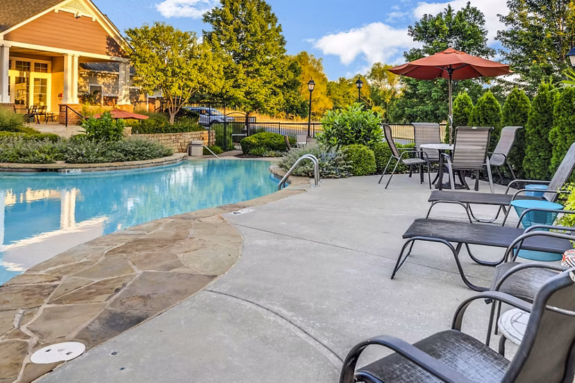 Outdoor pool with loungers at Aventura Clear Creek Apartments offering luxury living in a vibrant community