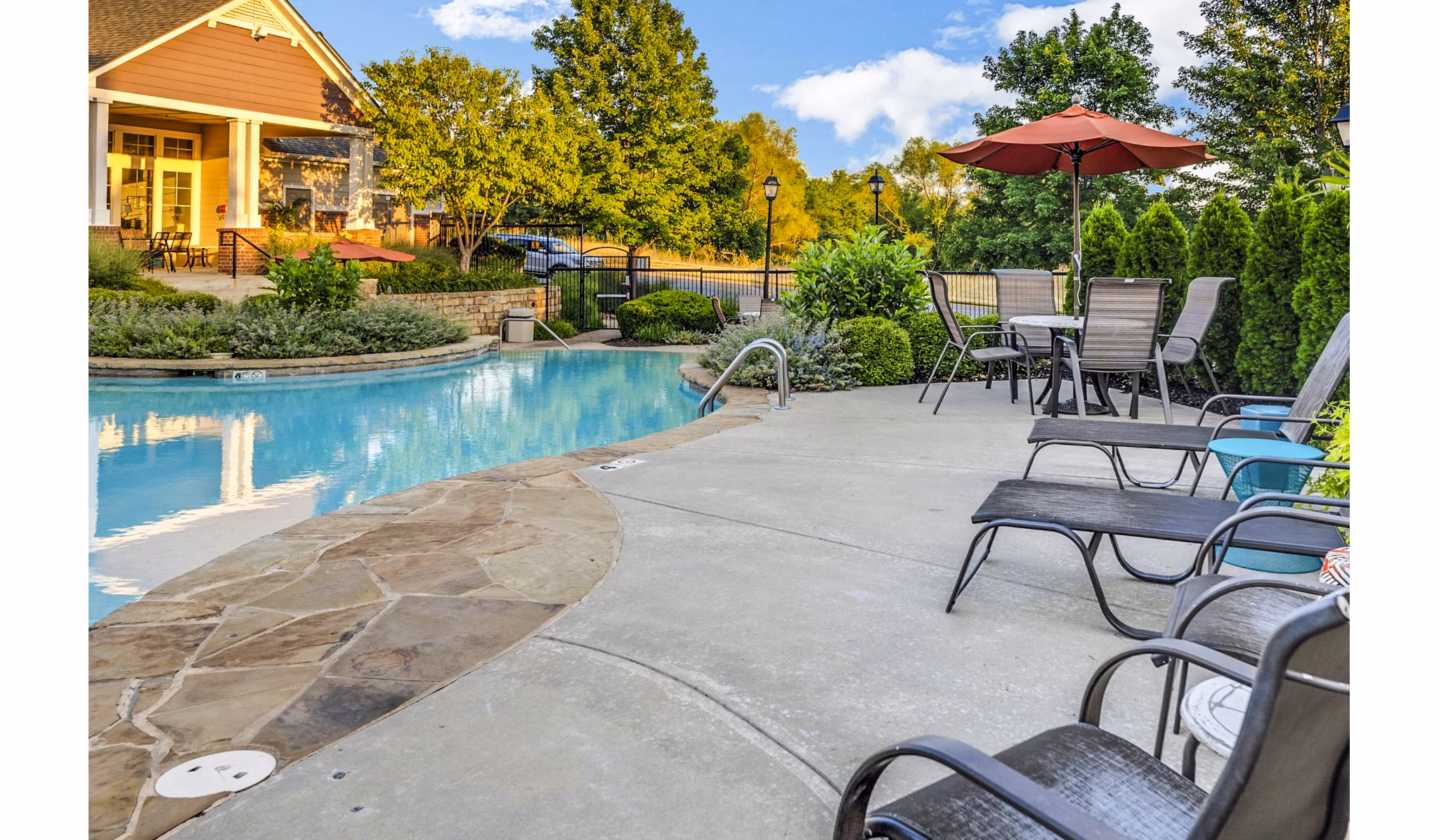Outdoor pool with loungers at Aventura Clear Creek Apartments offering luxury living in a vibrant community