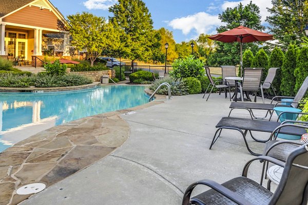 Outdoor pool with loungers at Aventura Clear Creek Apartments offering luxury living in a vibrant community