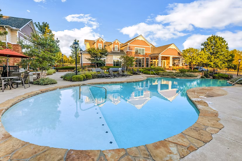 Resort-style pool with sun loungers at Aventura Clear Creek Apartments