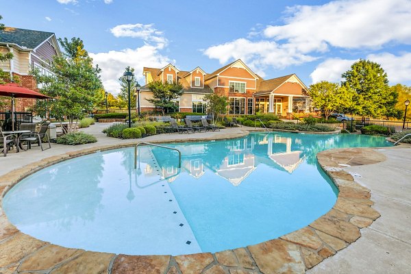 Resort-style pool with sun loungers at Aventura Clear Creek Apartments