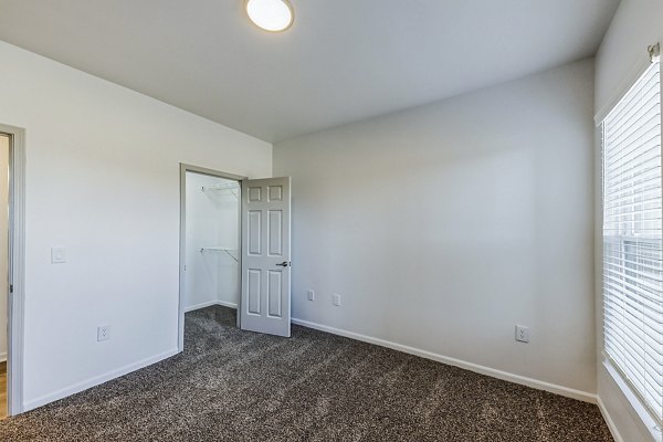 Bedroom featuring modern decor and spacious layout at Aventura Falcon Valley Apartments in Lenexa, KS.