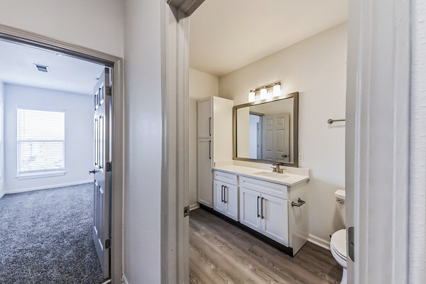 Luxurious bathroom with modern fixtures at Aventura Falcon Valley Apartments, featuring elegant design and spacious layout