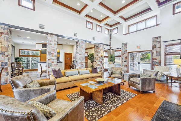 Clubhouse featuring modern design and cozy seating at Aventura Falcon Valley Apartments