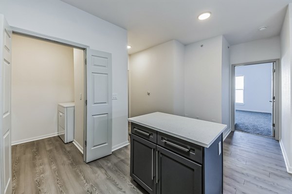 Modern kitchen with stainless steel appliances and granite countertops at Aventura Falcon Valley Apartments