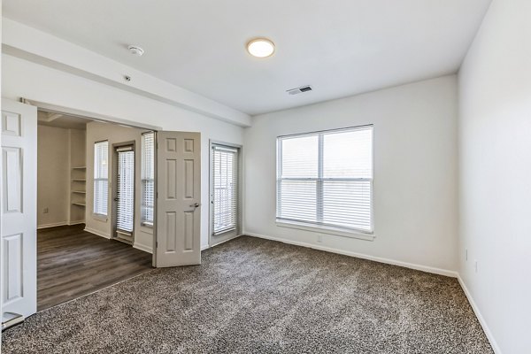 Bedroom featuring modern decor and abundant natural light at Aventura Falcon Valley Apartments